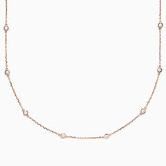 The 14K Rose Gold 18 Diamond Station Necklace features round bezel-set diamonds totaling 0.75 TCW, elegantly arranged and shown on a plain white background.