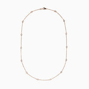 The 14K Rose Gold 18 Diamond Station Necklace features round bezel-set diamonds totaling 0.75 TCW, elegantly arranged and shown on a plain white background.