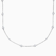 The 14K White Gold 18 Diamond Station Necklace boasts 1.50 TCW of round diamonds in bezel settings on a fine chain, shown against a white background.