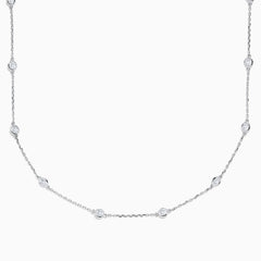 The 14K White Gold 18 Diamond Station Necklace boasts 1.50 TCW of round diamonds in bezel settings on a fine chain, shown against a white background.