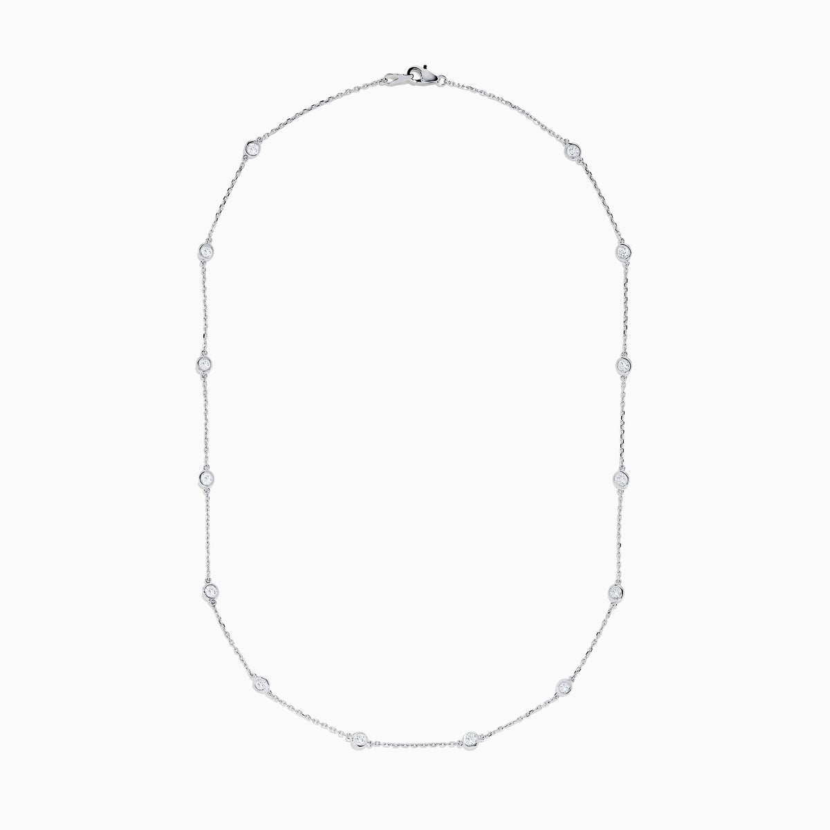 The 14K White Gold 18 Diamond Station Necklace boasts 1.50 TCW of round diamonds in bezel settings on a fine chain, shown against a white background.