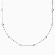 The 14K White Gold 18 Diamond Station Necklace features evenly spaced bezel-set round diamonds totaling 2.00 TCW, offering a simple, elegant, and minimalist design for timeless sophistication.