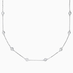 The 14K White Gold 18 Diamond Station Necklace features evenly spaced bezel-set round diamonds totaling 2.00 TCW, offering a simple, elegant, and minimalist design for timeless sophistication.