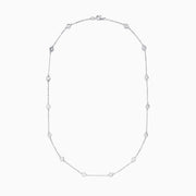 The 14K White Gold 18 Diamond Station Necklace features evenly spaced bezel-set round diamonds totaling 2.00 TCW, offering a simple, elegant, and minimalist design for timeless sophistication.