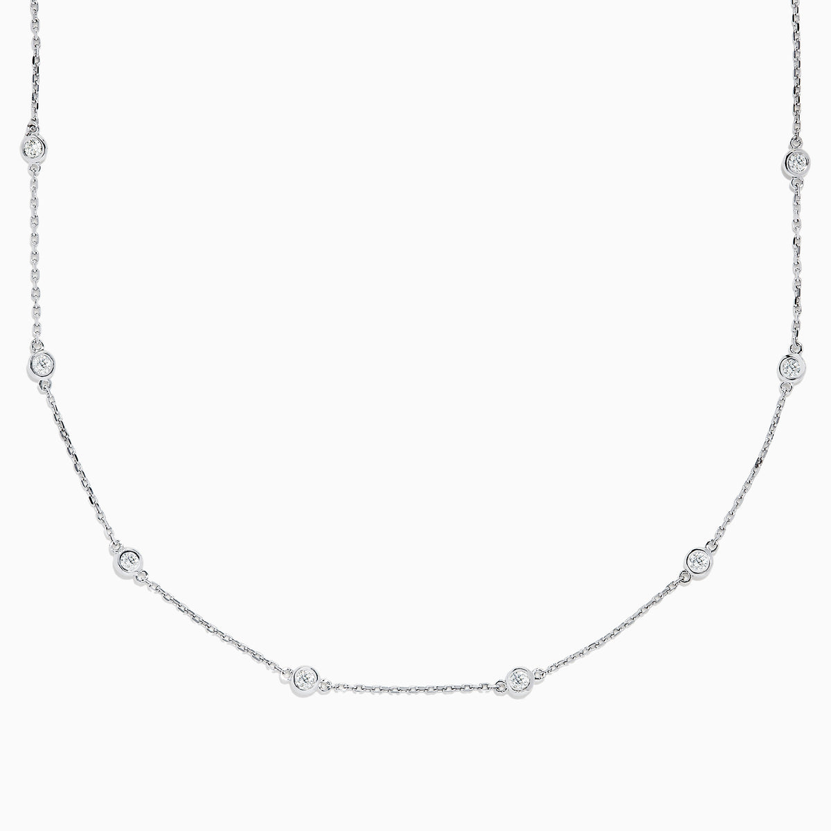 The 14K White Gold 18 Diamond Station Necklace showcases evenly spaced round bezel-set diamonds totaling 1.00 TCW, elegantly displayed against a white background.