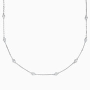 The 14K White Gold 18 Diamond Station Necklace showcases evenly spaced round bezel-set diamonds totaling 1.00 TCW, elegantly displayed against a white background.