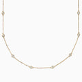 The 14K Yellow Gold 18 Diamond Station Necklace, 1.00 TCW, features small round bezel-set diamonds spaced along a delicate gold chain for an elegant, minimalist look.
