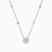 The 14K White Gold 18 Diamond Station and Flower Cluster Necklace (1.51 TCW) features a delicate flower cluster pendant and sparkling round diamonds along the chain, shown on a white background.