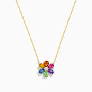 The Watercolors 14K Gold Multi Sapphire and Diamond Flower Necklace features a gold chain and a diamond flower pendant accented with eight colorful, teardrop-shaped sapphires arranged in a circle.