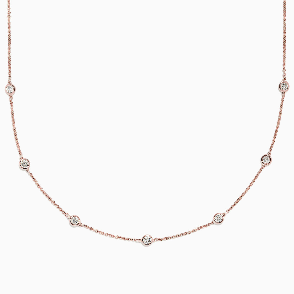 The Pave Rose 14K Rose Gold Diamond Station Necklace, 0.69 TCW, features round bezel-set diamonds spaced along a fine rose gold chain and is displayed on a plain white background.