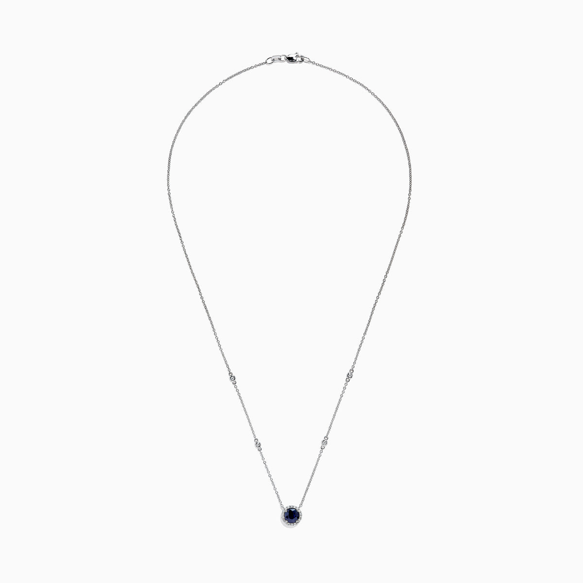 The Royale Bleu 14K White Gold Sapphire and Diamond Necklace, 1.11 TCW, features a round blue sapphire pendant with a halo of clear stones and two diamonds set along each side of the chain.