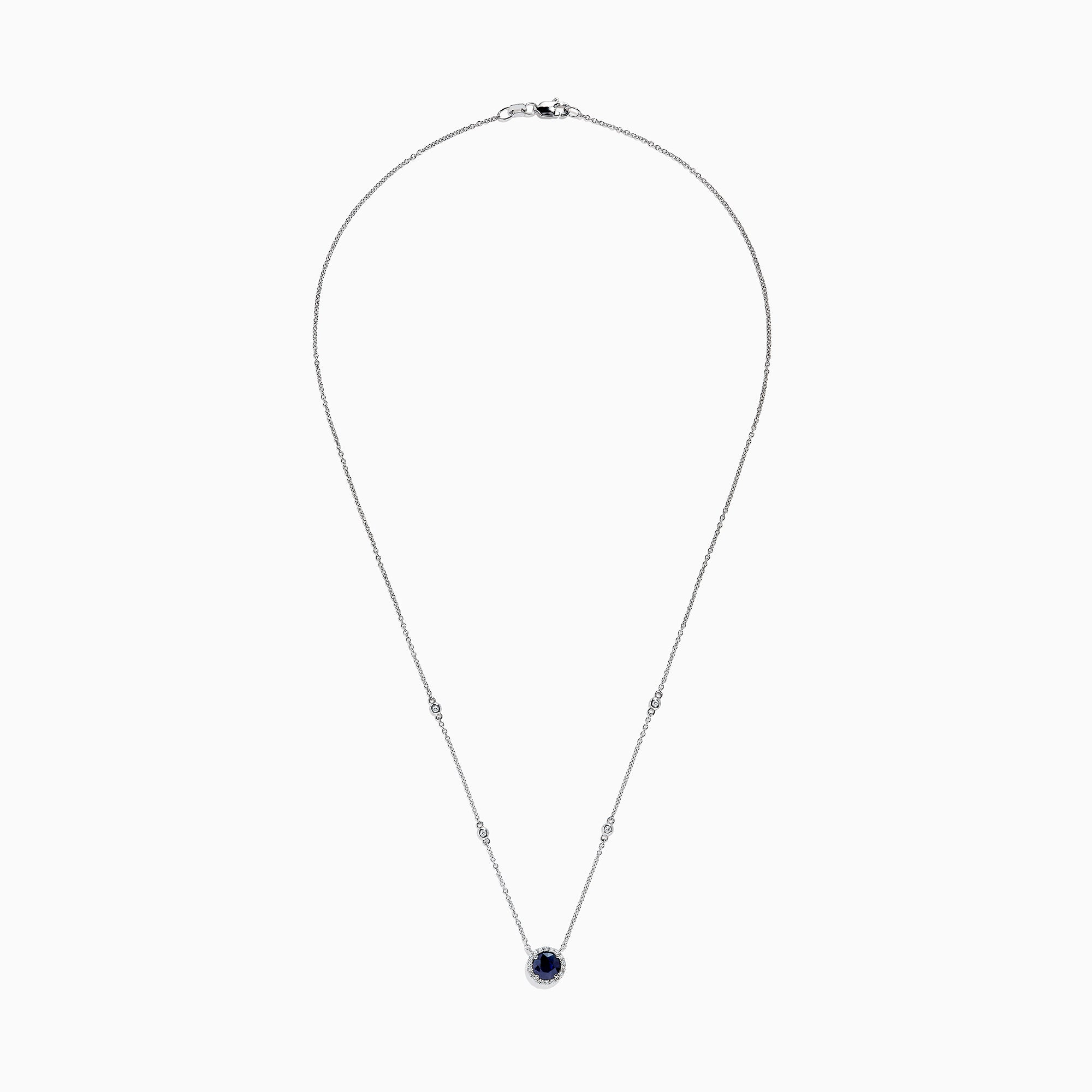 The Royale Bleu 14K White Gold Sapphire and Diamond Necklace, 1.11 TCW, features a round blue sapphire pendant with a halo of clear stones and two diamonds set along each side of the chain.