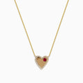 The Novelty 14K Yellow Gold Ruby and Diamond Heart Necklace, 0.29 TCW, showcases a heart-shaped pendant outlined with sparkling diamonds and accented by a single ruby on one side.