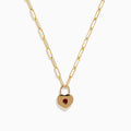 The Ruby Royale 14K Yellow Gold Ruby Heart Lock Necklace features elongated links and a heart-shaped padlock pendant set with a central ruby gemstone.