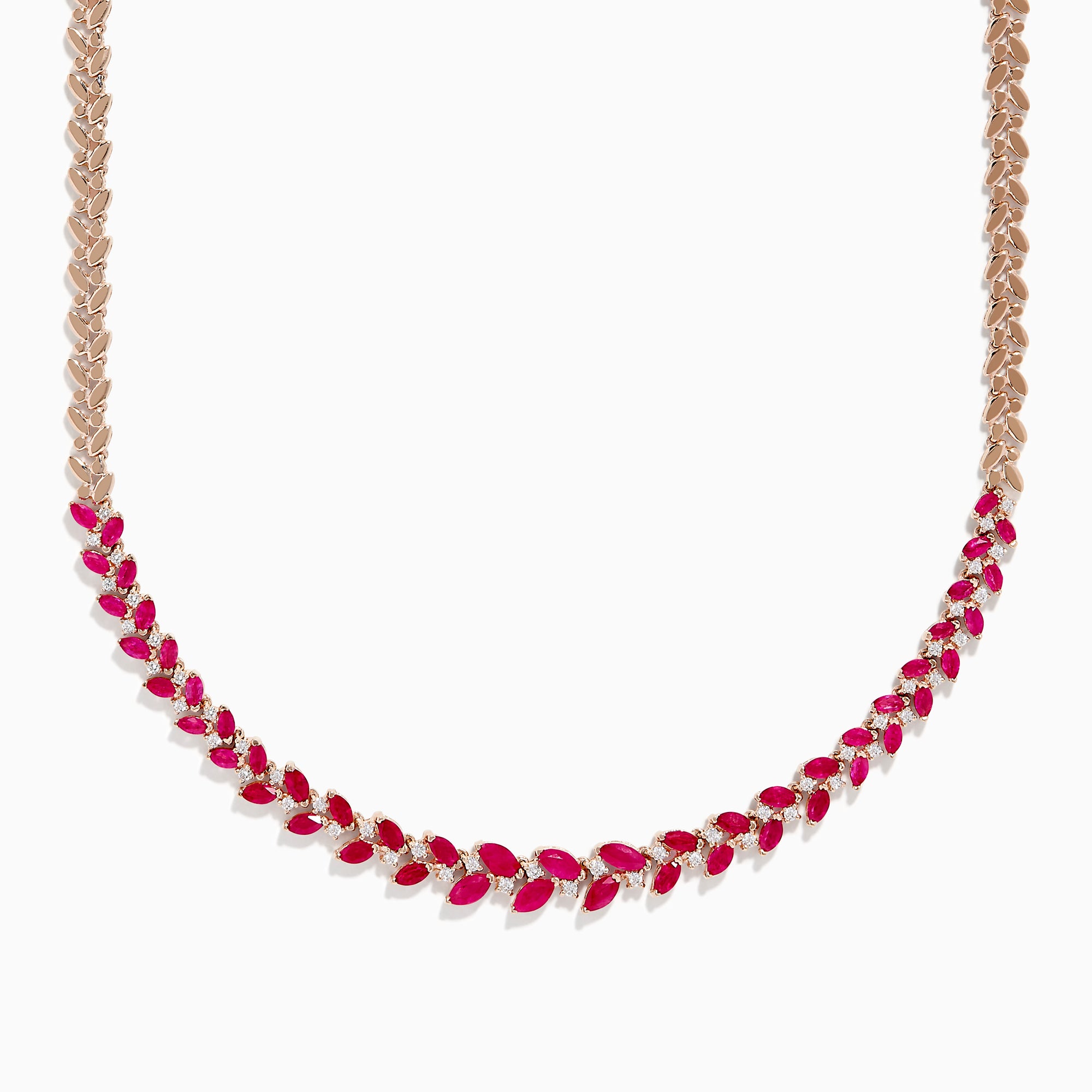 The Ruby Royale 14K Yellow Gold Ruby and Diamond Leaf Necklace showcases a leaf-inspired design with alternating rubies and diamonds in front, smoothly transitioning to a sleek yellow gold pattern at the back.