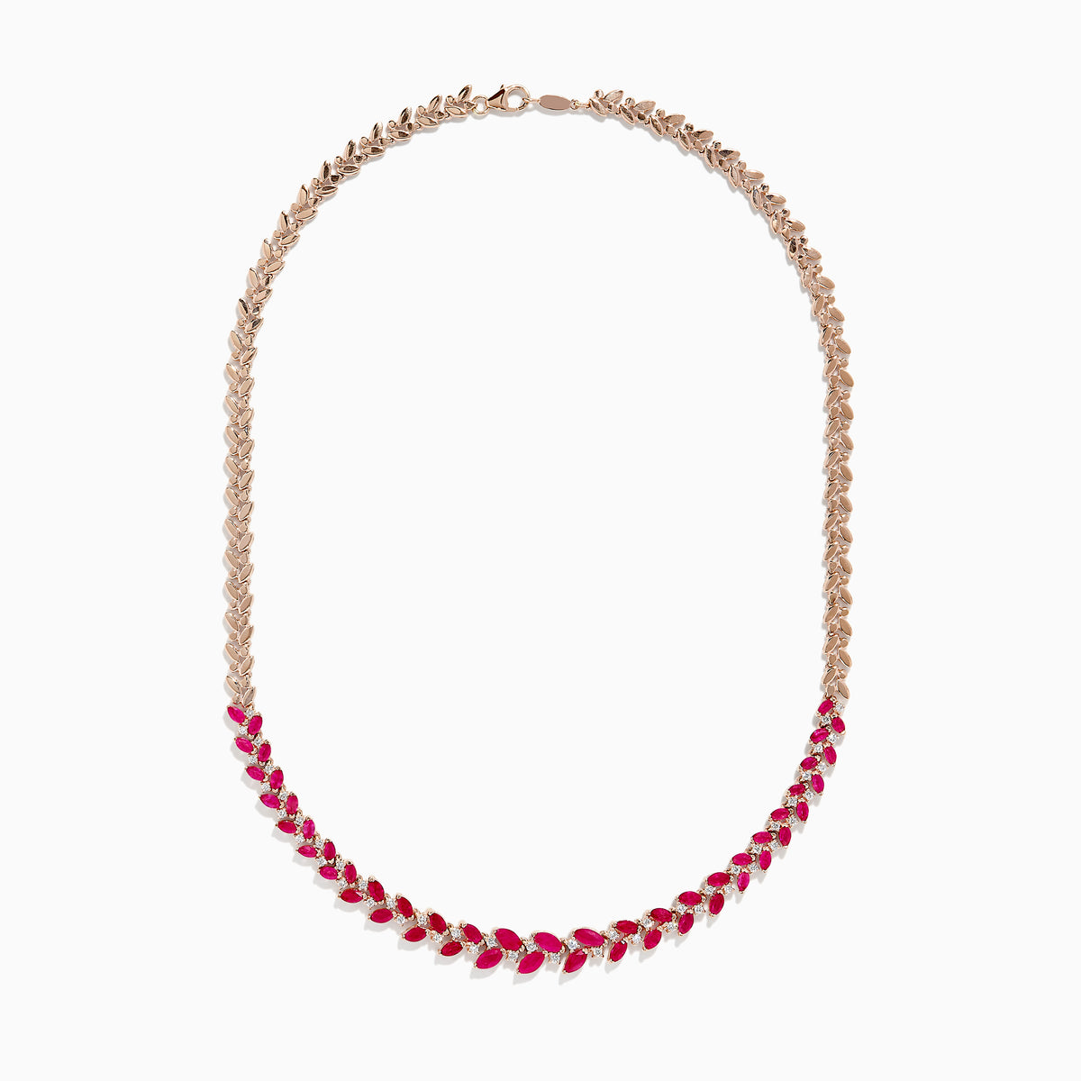The Ruby Royale 14K Yellow Gold Ruby and Diamond Leaf Necklace showcases a leaf-inspired design with alternating rubies and diamonds in front, smoothly transitioning to a sleek yellow gold pattern at the back.