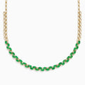 A beautiful 14K yellow gold necklace with two chains, featuring a row of oval emeralds and diamonds along the front for a timeless, elegant look.