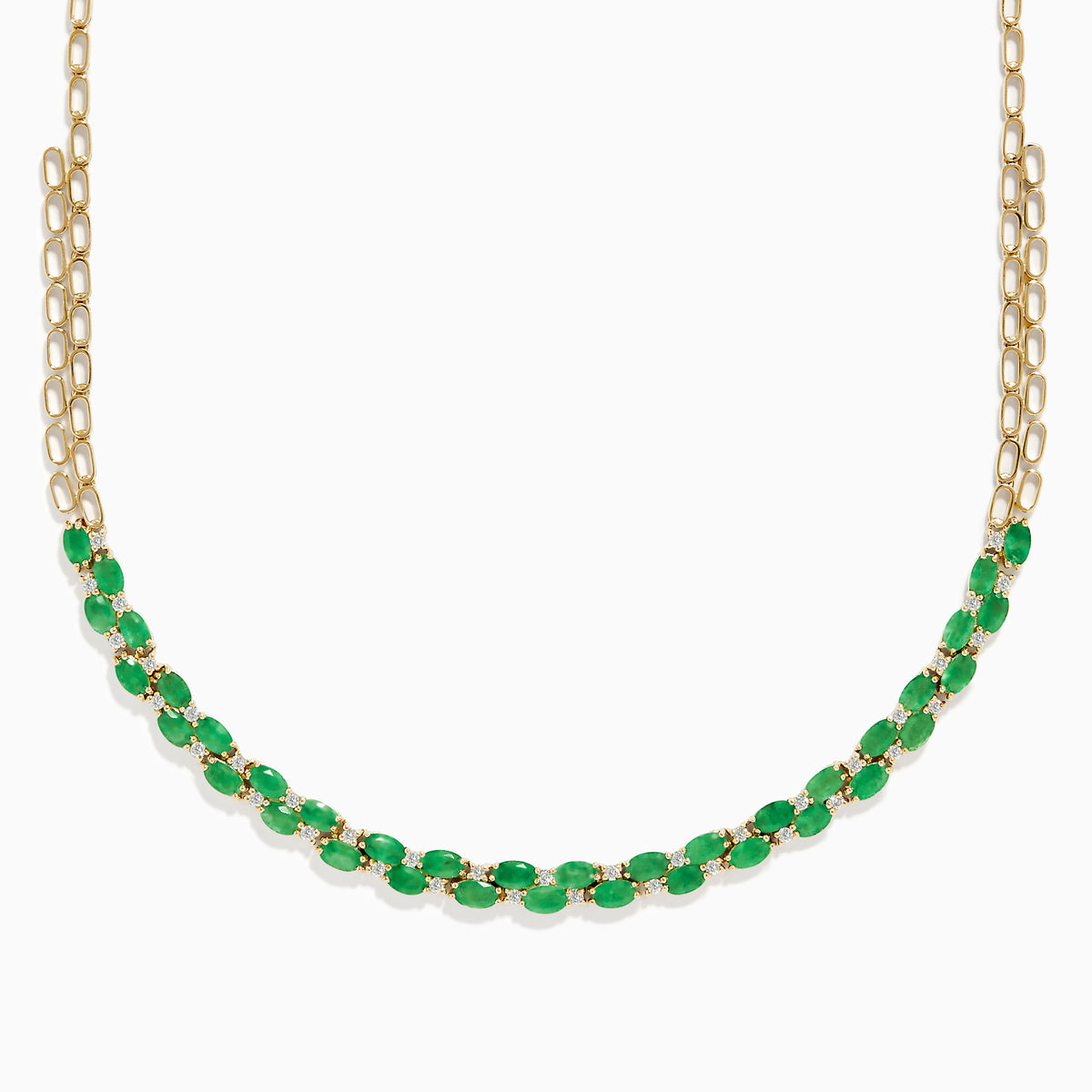 A beautiful 14K yellow gold necklace with two chains, featuring a row of oval emeralds and diamonds along the front for a timeless, elegant look.
