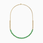 A beautiful 14K yellow gold necklace with two chains, featuring a row of oval emeralds and diamonds along the front for a timeless, elegant look.