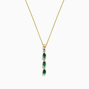 A 14k yellow gold pendant by Effy, featuring three emeralds and four diamonds (0.57 TCW) in an alternating vertical design, hangs from a delicate chain for an elegant look.
