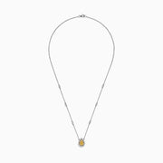 The Canare 18K Two-Tone Gold Yellow and White Diamond Necklace (0.69 TCW) features a teardrop pendant with a yellow gemstone encircled by white diamonds, set on a gold chain accented with spaced round gemstones.
