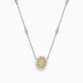The Canare 14K White Gold Oval Halo Yellow Diamond Pendant Necklace, 0.81 TCW, features a central oval yellow diamond surrounded by clear stones on a silver chain for an elegant, radiant look.