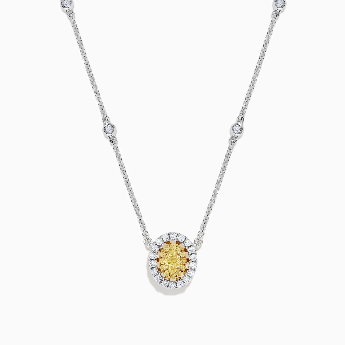 The Canare 14K White Gold Oval Halo Yellow Diamond Pendant Necklace, 0.81 TCW, features a central oval yellow diamond surrounded by clear stones on a silver chain for an elegant, radiant look.