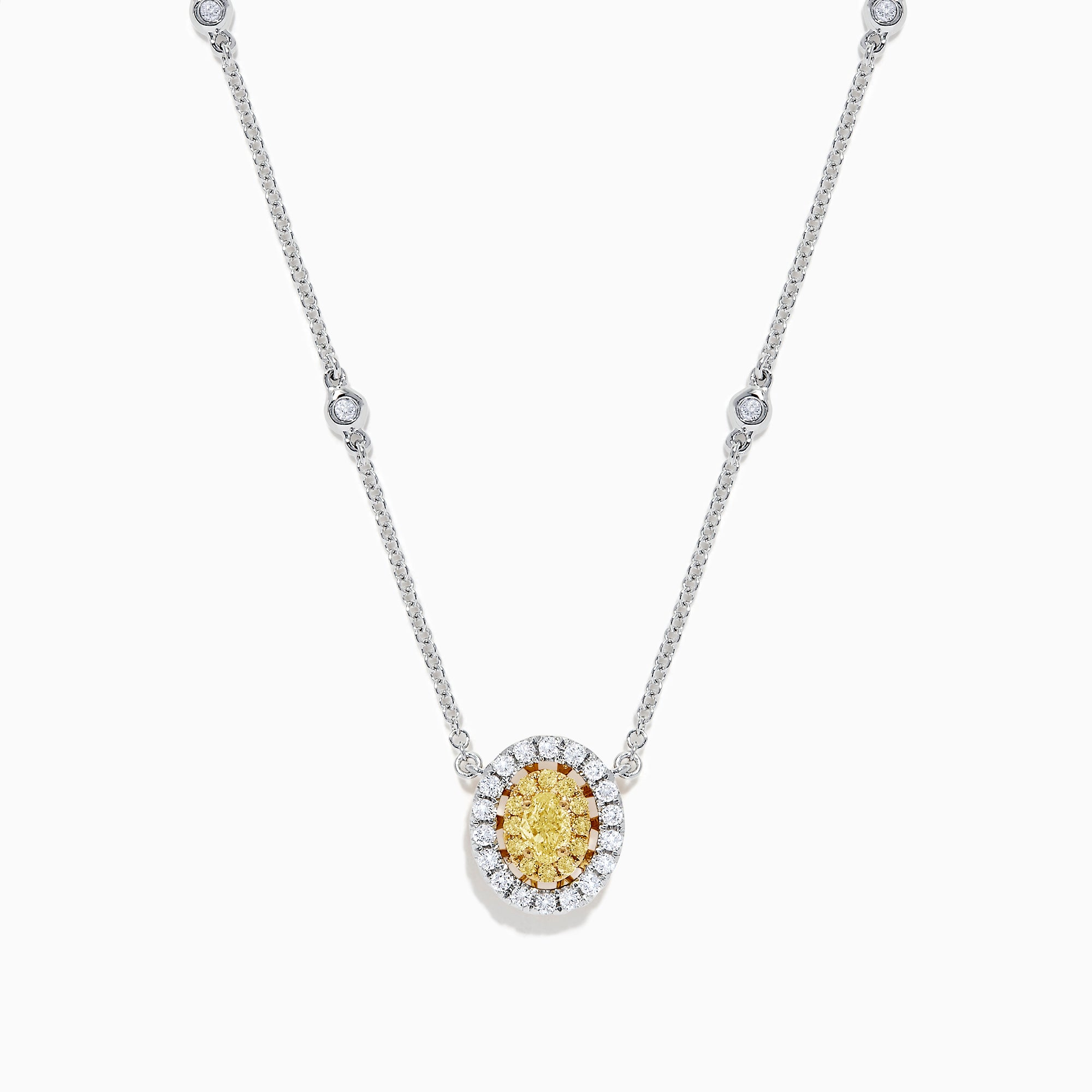 The Canare 14K White Gold Oval Halo Yellow Diamond Pendant Necklace, 0.81 TCW, features a central oval yellow diamond surrounded by clear stones on a silver chain for an elegant, radiant look.