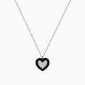 The Novelty 14K White Gold Black Enamel & Diamond Heart Pendant, 0.18 TCW, hangs from a delicate silver chain and features a heart outlined in black enamel with sparkling diamonds at the center.