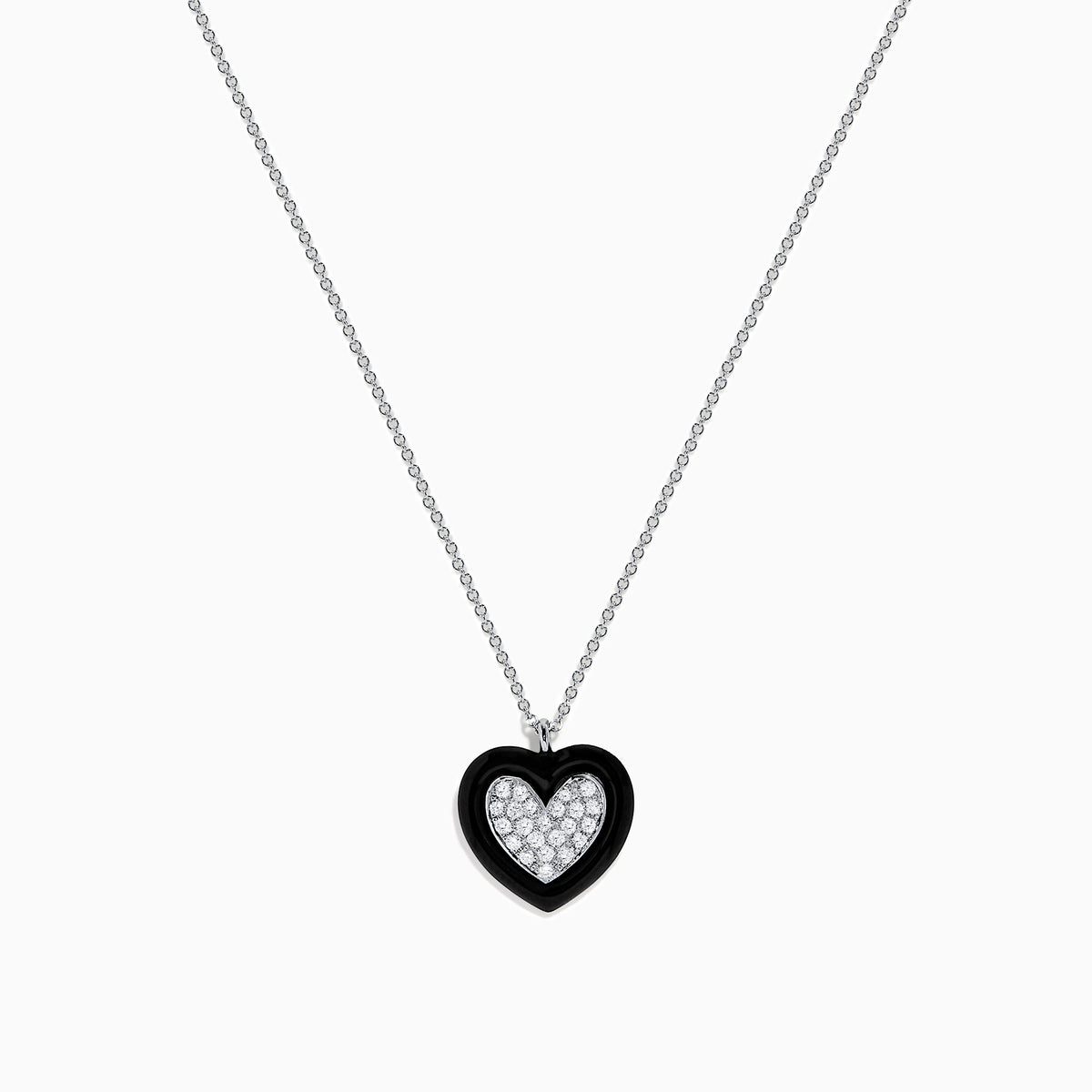 The Novelty 14K White Gold Black Enamel & Diamond Heart Pendant, 0.18 TCW, hangs from a delicate silver chain and features a heart outlined in black enamel with sparkling diamonds at the center.