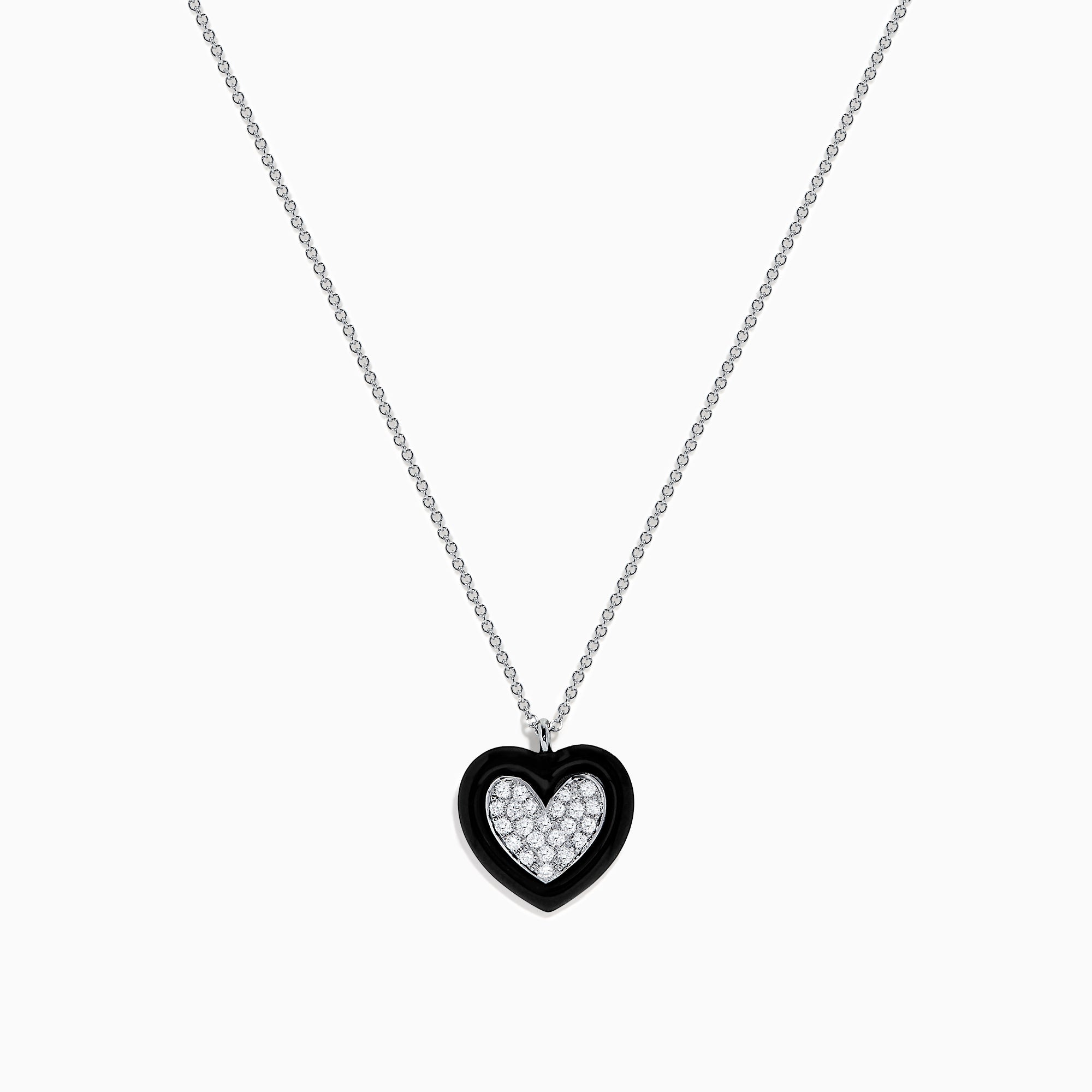 The Novelty 14K White Gold Black Enamel & Diamond Heart Pendant, 0.18 TCW, hangs from a delicate silver chain and features a heart outlined in black enamel with sparkling diamonds at the center.