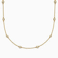 The D’Oro 14K Yellow Gold Diamond Station Necklace features evenly spaced bezel-set diamonds totaling 1.50 TCW, each set in a small gold frame along the chain, displayed on a plain white background.