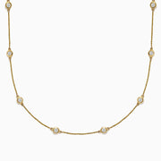 The D’Oro 14K Yellow Gold Diamond Station Necklace features evenly spaced bezel-set diamonds totaling 1.50 TCW, each set in a small gold frame along the chain, displayed on a plain white background.