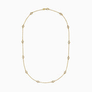 The D’Oro 14K Yellow Gold Diamond Station Necklace features evenly spaced bezel-set diamonds totaling 1.50 TCW, each set in a small gold frame along the chain, displayed on a plain white background.