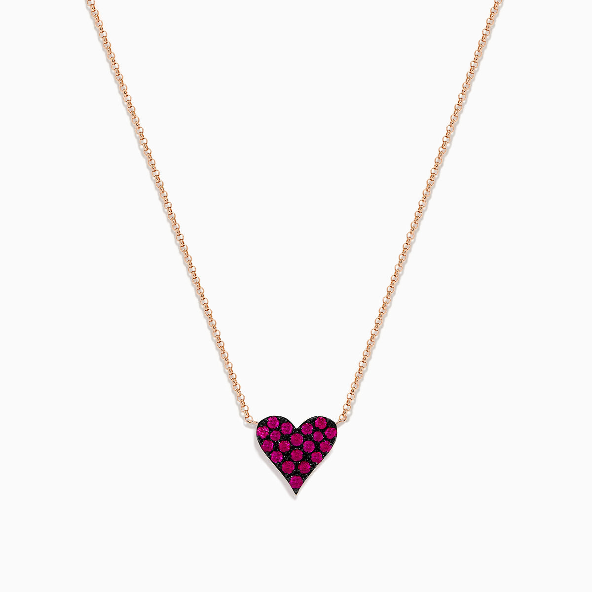 The 14K Rose Gold Ruby Pave Heart Necklace features a heart-shaped pendant encrusted with sparkling rubies on a delicate rose gold chain, displayed against a plain white background.