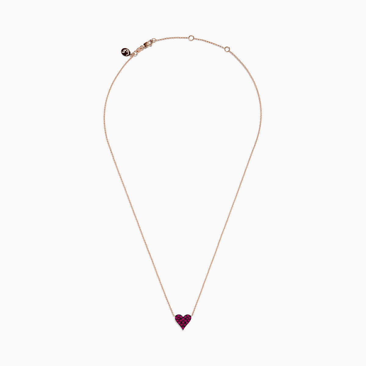 The 14K Rose Gold Ruby Pave Heart Necklace features a heart-shaped pendant encrusted with sparkling rubies on a delicate rose gold chain, displayed against a plain white background.