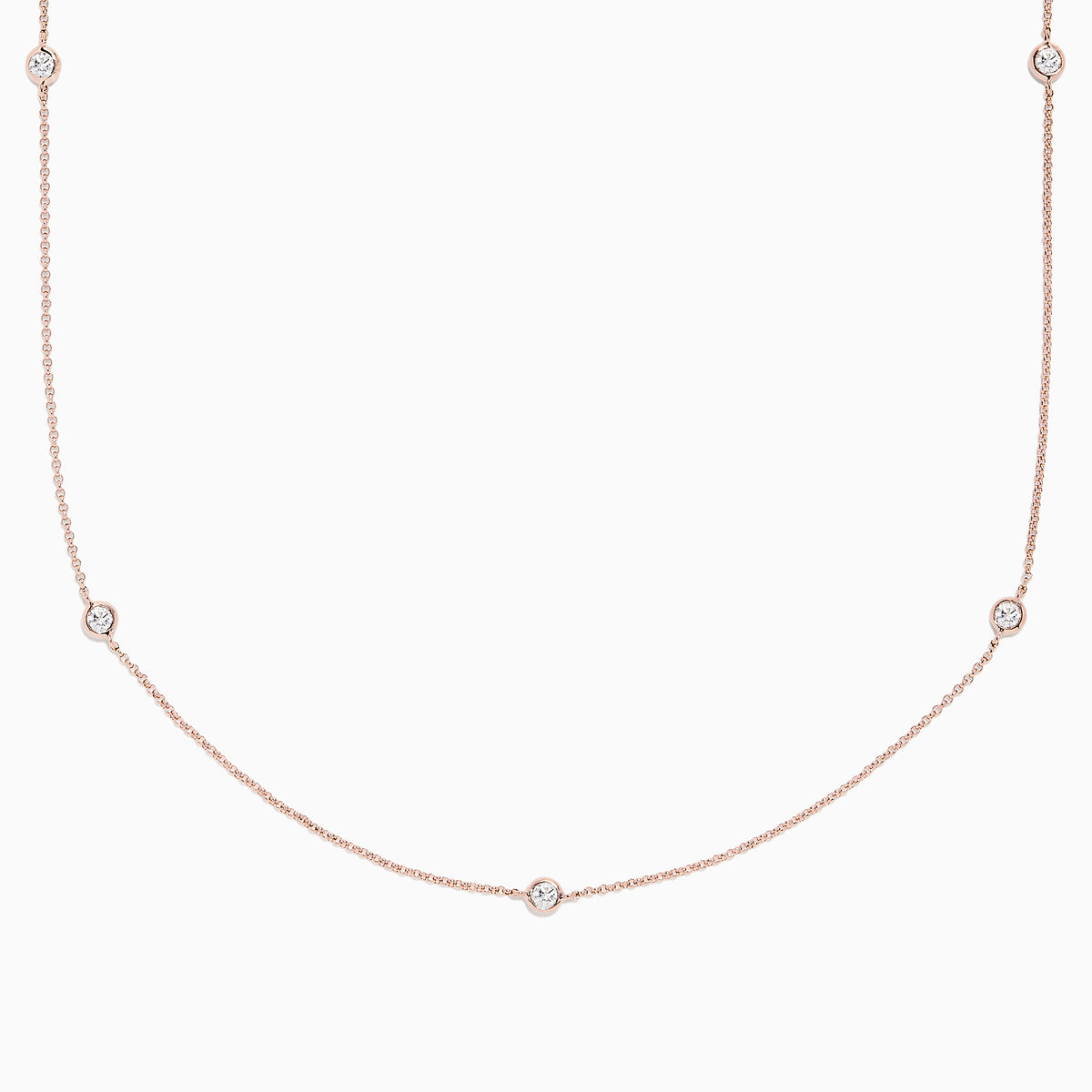 The Pave Rose 14K Rose Gold Diamond Station Necklace (0.62 TCW) features delicately bezel-set round diamonds, offering a minimal and elegant look against a plain white background.