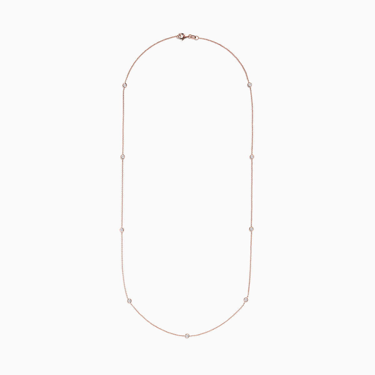The Pave Rose 14K Rose Gold Diamond Station Necklace (0.62 TCW) features delicately bezel-set round diamonds, offering a minimal and elegant look against a plain white background.