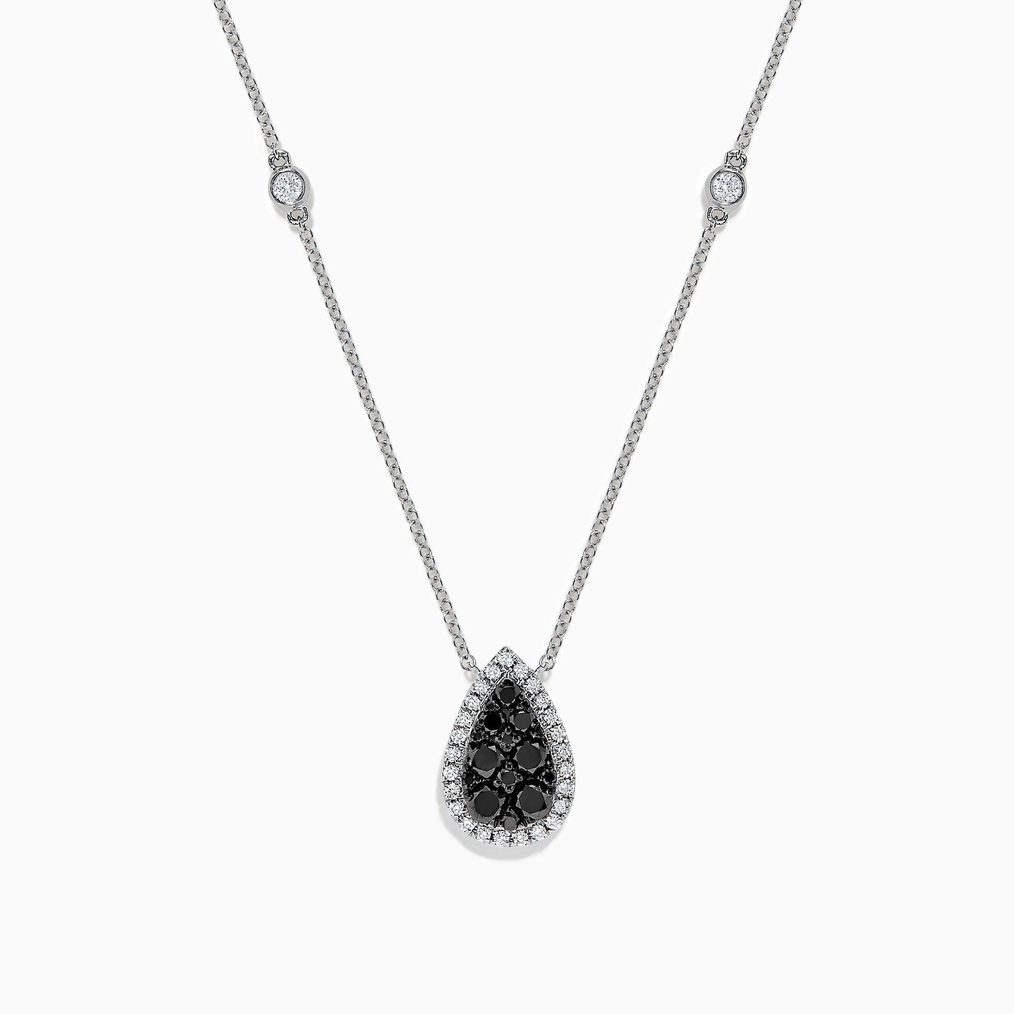 The 14K White Gold Black and White Diamond Pear Shaped Necklace, 1.09 TCW, features a teardrop pendant with black and white diamonds at the center, haloed by clear stones, plus two small clear stones set along the chain.