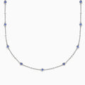 The 14K White Gold Diamond and Tanzanite Stationary Necklace showcases alternating round tanzanite and diamond gems set along a fine chain, displayed against a white background.