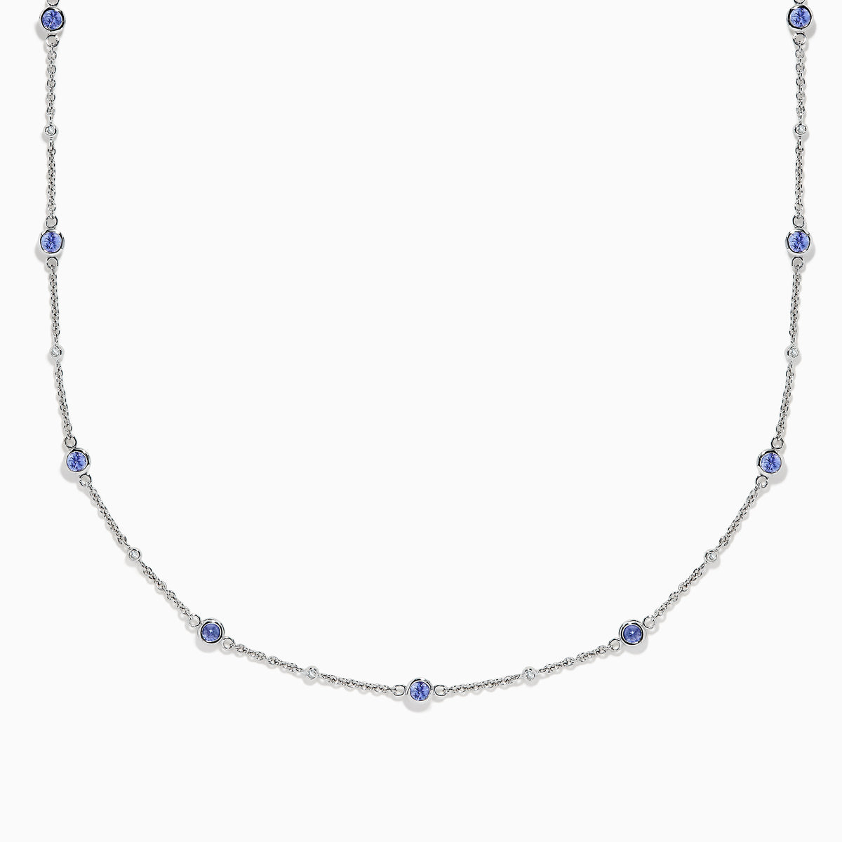 The 14K White Gold Diamond and Tanzanite Stationary Necklace showcases alternating round tanzanite and diamond gems set along a fine chain, displayed against a white background.