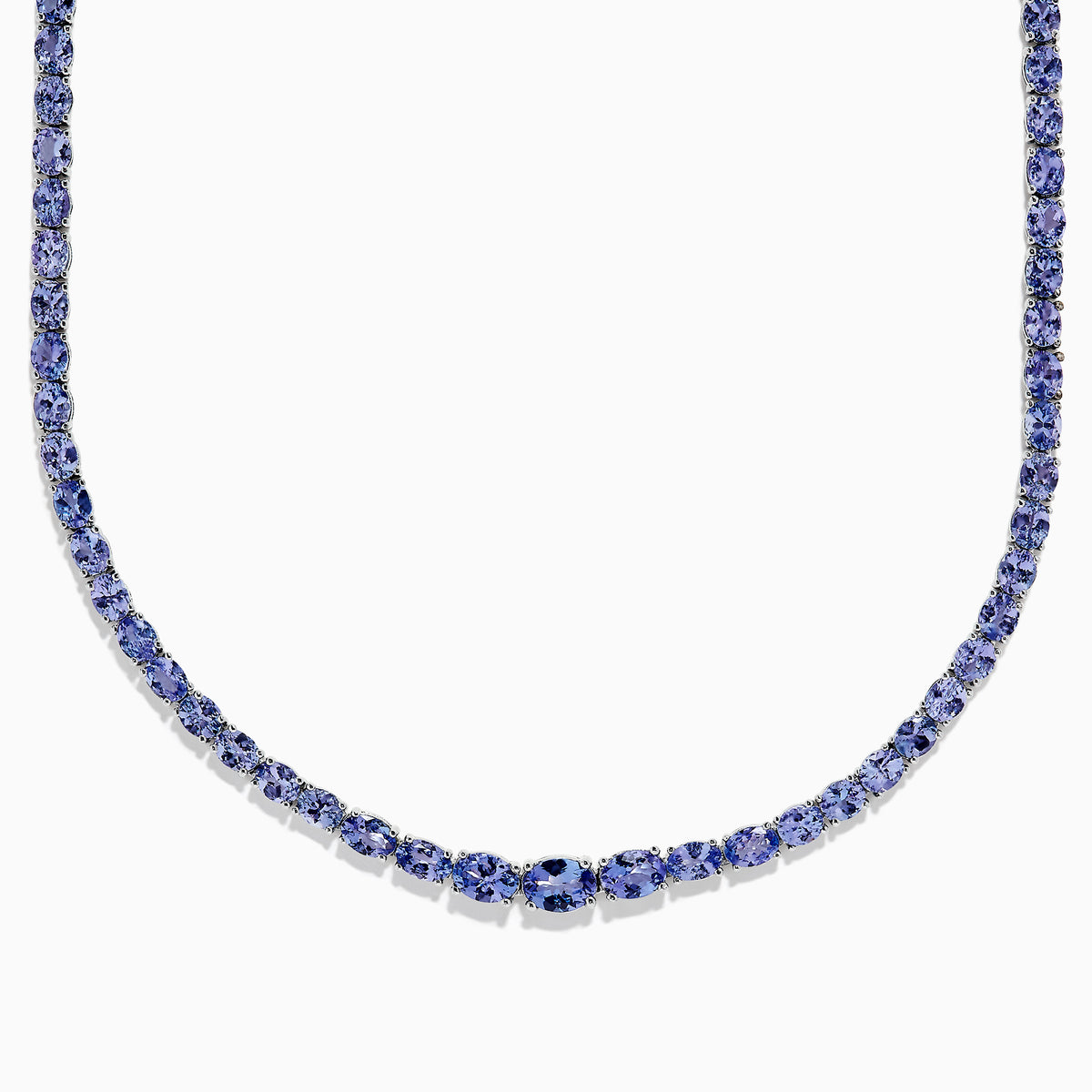 A close-up of the Nahla Siri Sterling Silver Tanzanite Necklace, 27.69 TCW, showcasing a continuous strand of round, faceted blue tanzanite gemstones set symmetrically against a white background.