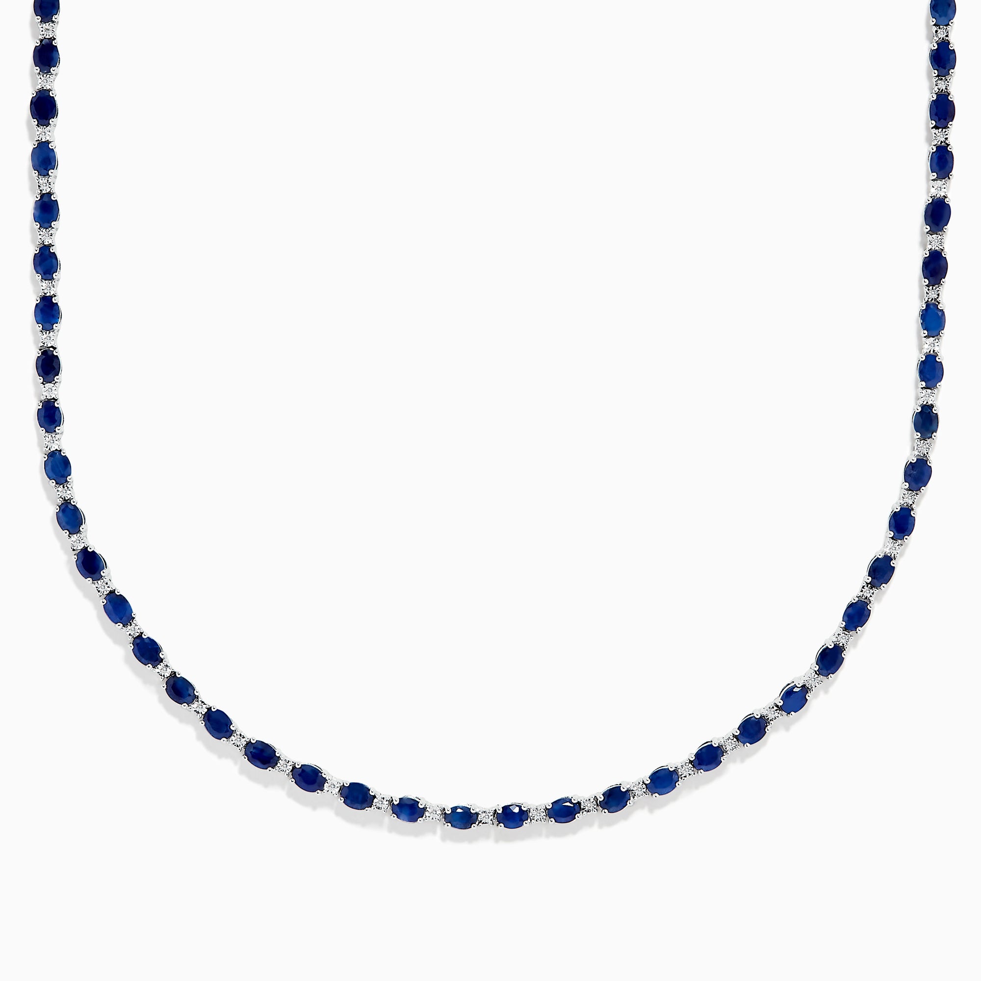 The 925 Sterling Silver Blue Sapphire Tennis Necklace features a continuous line of round blue sapphires set in sterling silver, creating a simple and elegant design.