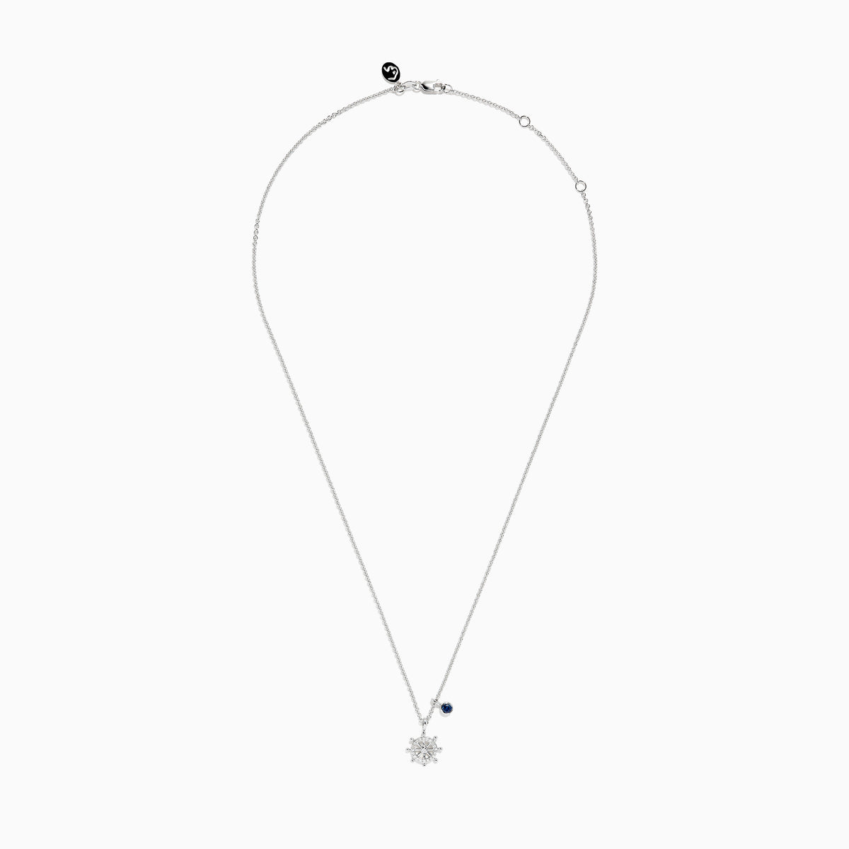 The Seaside Sterling Silver Diamond and Sapphire Ship Wheel Pendant features a ship wheel design with diamond accents and a sapphire charm, showcased on a sterling silver chain against a white background.