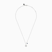 The Seaside Sterling Silver Diamond and Sapphire Ship Wheel Pendant features a ship wheel design with diamond accents and a sapphire charm, showcased on a sterling silver chain against a white background.