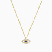 The Novelty 14K Yellow Gold Sapphire and Diamond Evil Eye Pendant features an eye-shaped design with sparkling stones and a central sapphire, resembling a classic talisman necklace.