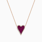 The Ruby Royale 14K Rose Gold Pave Ruby Heart Pendant Necklace features a heart-shaped pendant adorned with pave rubies and bordered by clear stones, set in an elegant rose gold setting.