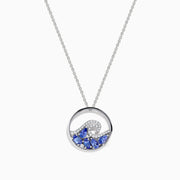The 925 Sterling Silver Tanzanite and Diamond Wave Pendant features a circular wave design with sparkling blue tanzanite and clear gemstones on a delicate chain, offering an elegant, ocean-inspired look.