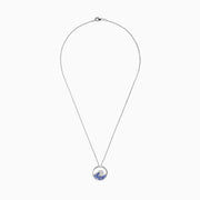 The 925 Sterling Silver Tanzanite and Diamond Wave Pendant features a circular wave design with sparkling blue tanzanite and clear gemstones on a delicate chain, offering an elegant, ocean-inspired look.