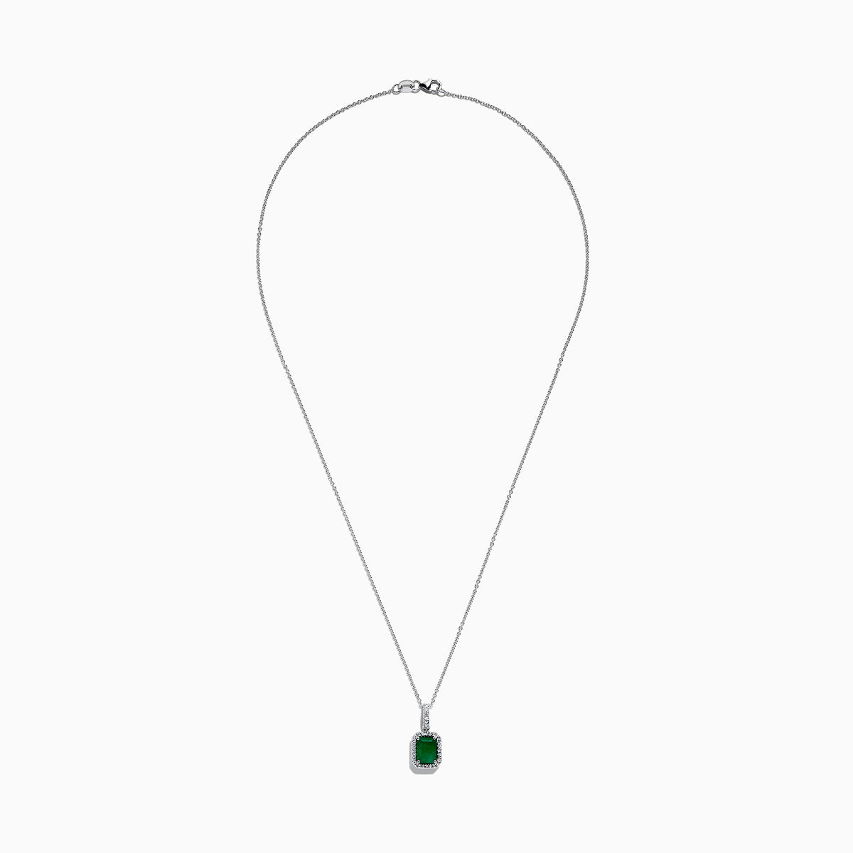 The Brasilica 14K White Gold Emerald and Diamond Pendant (1.55 TCW) features a rectangular emerald accented by a border of diamonds on a delicate chain, shown against a plain white background.